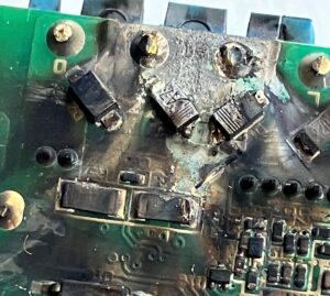 A charred circuit board, having experienced a catastrophic failure